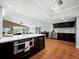 Open concept kitchen with island, wine fridge, and stainless steel appliances at 5645 Churchill Downs Rd, Sarasota, FL 34241