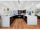 Modern kitchen with double ovens, island, and wine cooler at 5645 Churchill Downs Rd, Sarasota, FL 34241