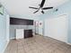 Small kitchenette with dark cabinets and tile floor at 5645 Churchill Downs Rd, Sarasota, FL 34241