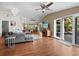 Open living room with hardwood floors, ceiling fan, and access to deck at 5645 Churchill Downs Rd, Sarasota, FL 34241