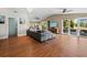 Spacious living room with hardwood floors, large windows, and access to a deck at 5645 Churchill Downs Rd, Sarasota, FL 34241