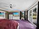 Main bedroom with purple carpet, large windows and access to backyard at 5645 Churchill Downs Rd, Sarasota, FL 34241