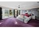 Main bedroom with purple carpet, large windows and access to patio at 5645 Churchill Downs Rd, Sarasota, FL 34241