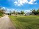 Spacious grassy yard with a fenced dog run area at 5645 Churchill Downs Rd, Sarasota, FL 34241