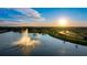 Aerial view of community lake with fountain at sunset at 6138 162Nd E Ave, Parrish, FL 34219