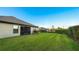 Spacious backyard with grassy lawn and privacy hedge at 6138 162Nd E Ave, Parrish, FL 34219