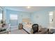 Bright bedroom with a queen bed, desk, and window coverings at 6138 162Nd E Ave, Parrish, FL 34219