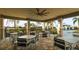 Covered patio area with tables and chairs near pool at 6138 162Nd E Ave, Parrish, FL 34219
