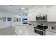 Modern kitchen with white cabinets, granite countertops, and an island at 6138 162Nd E Ave, Parrish, FL 34219