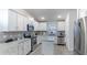 Well-equipped kitchen featuring white cabinetry, granite counters, and breakfast bar at 6138 162Nd E Ave, Parrish, FL 34219