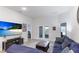 Relaxing living room featuring a sectional sofa, large TV, and access to a patio at 6138 162Nd E Ave, Parrish, FL 34219