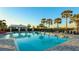 Inviting community pool with lounge chairs and palm trees at 6138 162Nd E Ave, Parrish, FL 34219
