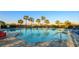Relaxing community pool with palm trees and lounge chairs at 6138 162Nd E Ave, Parrish, FL 34219