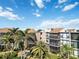 Aerial view of community, highlighting building and palm trees at 618 Bird Bay S Dr # 201, Venice, FL 34285