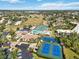 Aerial view of community amenities including tennis courts, pool, and parking at 618 Bird Bay S Dr # 201, Venice, FL 34285