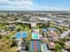 Aerial view of community with tennis courts, pool, and surrounding landscape at 618 Bird Bay S Dr # 201, Venice, FL 34285