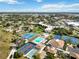 Aerial view showing tennis courts, pool, and residential buildings in a community at 618 Bird Bay S Dr # 201, Venice, FL 34285
