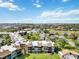 Aerial view of community, featuring multiple buildings, tennis courts, pool, and lush landscaping at 618 Bird Bay S Dr # 201, Venice, FL 34285