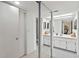 Bathroom with a double vanity and mirrored sliding doors at 618 Bird Bay S Dr # 201, Venice, FL 34285