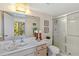 Bathroom with a single sink vanity and a walk-in shower at 618 Bird Bay S Dr # 201, Venice, FL 34285