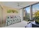 Bedroom with daybed, leafy decor, and sliding glass doors at 618 Bird Bay S Dr # 201, Venice, FL 34285