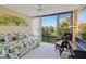 Bedroom with daybed, leafy decor, and patio access at 618 Bird Bay S Dr # 201, Venice, FL 34285