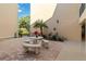 Relaxing courtyard with table, benches, and lush greenery at 618 Bird Bay S Dr # 201, Venice, FL 34285