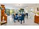 Bright dining area with glass table and blue chairs at 618 Bird Bay S Dr # 201, Venice, FL 34285