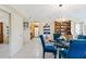 Dining area with glass table and blue chairs, kitchen view at 618 Bird Bay S Dr # 201, Venice, FL 34285