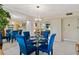 Dining area with glass table and blue chairs, entryway view at 618 Bird Bay S Dr # 201, Venice, FL 34285