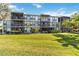 Building exterior with balconies and green space at 618 Bird Bay S Dr # 201, Venice, FL 34285