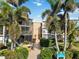 Building entrance with lush landscaping and signage at 618 Bird Bay S Dr # 201, Venice, FL 34285