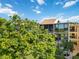 Condo building with screened balconies and lush foliage at 618 Bird Bay S Dr # 201, Venice, FL 34285
