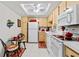 Clean kitchen with white appliances and light wood cabinets at 618 Bird Bay S Dr # 201, Venice, FL 34285