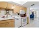 Efficient kitchen, featuring white appliances and ample cabinetry at 618 Bird Bay S Dr # 201, Venice, FL 34285