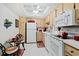 Well-equipped kitchen with white appliances and light wood cabinets at 618 Bird Bay S Dr # 201, Venice, FL 34285