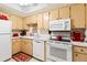Updated kitchen with white appliances and light wood cabinets at 618 Bird Bay S Dr # 201, Venice, FL 34285