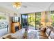 Living room with leather couch, balcony view, and fireplace at 618 Bird Bay S Dr # 201, Venice, FL 34285