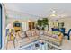 Tan leather sectional sofa anchors this living room overlooking dining area at 618 Bird Bay S Dr # 201, Venice, FL 34285