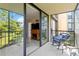Bright balcony with sliding glass doors and seating at 618 Bird Bay S Dr # 201, Venice, FL 34285