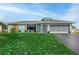 Charming ranch home with a newly paved driveway and well-manicured lawn at 625 Ennis Nw Ter, Port Charlotte, FL 33952