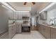 Modern kitchen with gray cabinets, granite countertops, and stainless steel appliances at 625 Ennis Nw Ter, Port Charlotte, FL 33952