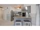 Kitchen with breakfast bar, gray cabinets, and granite counters at 625 Ennis Nw Ter, Port Charlotte, FL 33952