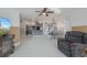 Open living room features tile floors and a view of the kitchen and dining area at 625 Ennis Nw Ter, Port Charlotte, FL 33952