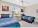Charming bedroom with two twin beds, dresser, and window with blinds at 6505 Stone River Rd # 202, Bradenton, FL 34203