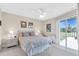 Main bedroom with patio access and view at 6505 Stone River Rd # 202, Bradenton, FL 34203