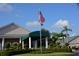 Community clubhouse with welcoming entrance and landscaping at 6505 Stone River Rd # 202, Bradenton, FL 34203