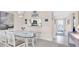 Dining room with glass-top table and view into kitchen and hallway at 6505 Stone River Rd # 202, Bradenton, FL 34203