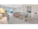 Bright dining room with glass table and chairs, and kitchen passthrough at 6505 Stone River Rd # 202, Bradenton, FL 34203