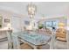 Spacious dining area with glass-top table and chandelier at 6505 Stone River Rd # 202, Bradenton, FL 34203